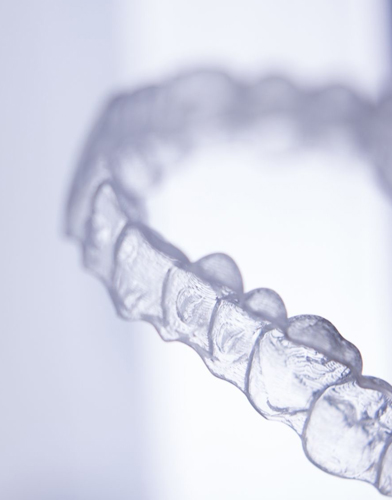 A clear orthodontic aligner like Invisalign for info on rough teeth edges after treatment