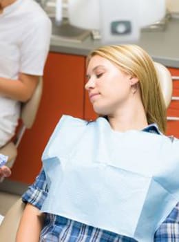 Dental sedation allows a young woman to relax in the dental chair